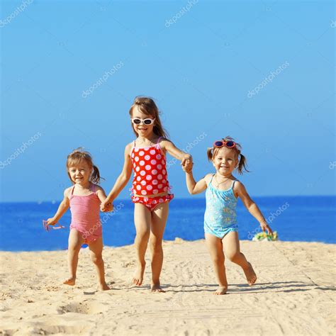 Kids playing at the beach Stock Photo by ©alenkasm 6069957