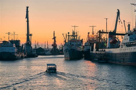 Premium Photo | Ships in sea port on sunset