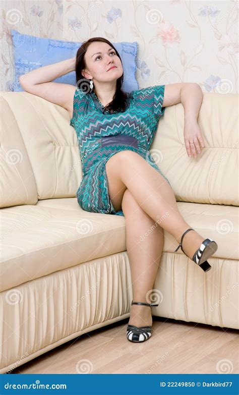 Woman sitting on the sofa stock photo. Image of dress - 22249850