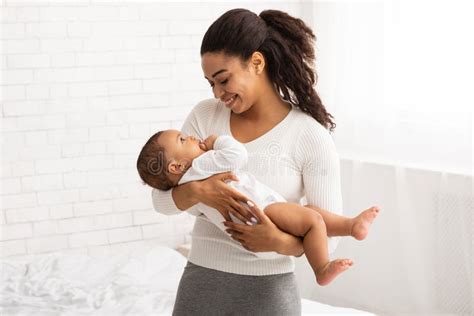 Black Mom Holding Baby in Arms Standing in Bedroom Indoor Stock Image ...