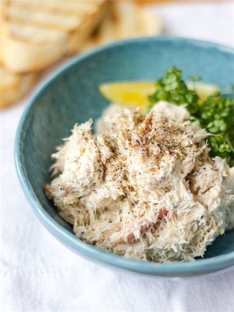 Pile of Smoked Mackerel pate in a green bowl with cress and a wedge of ...