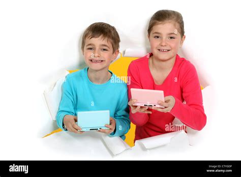 Kids with portable games console Stock Photo - Alamy