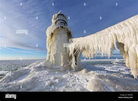 Ice covered St. Joseph pier light in winter. St. Joseph Michigan. On ...