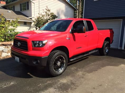 a red truck parked in front of a house