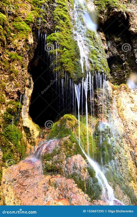 Cave Entrance Hidden Behind a Small Waterfall. Stalactite Cave in the ...