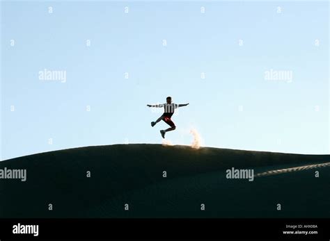 Boy jumping on a dune at Imperial Sand Dunes California Stock Photo - Alamy