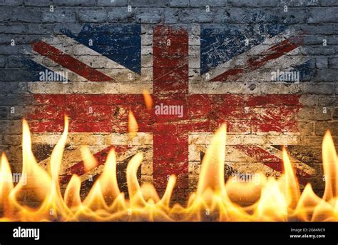 Close up wall with painted British UK flag in flames as symbol of world ...