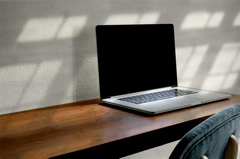 Laptop mockup on a wooden table 1310345 Stock Photo at Vecteezy