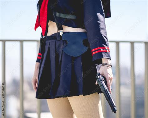 Girl with anime cosplay costume and a gun (similar to a police officer ...