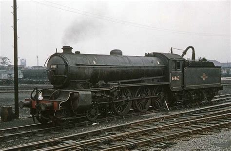 an old fashioned steam engine on the tracks