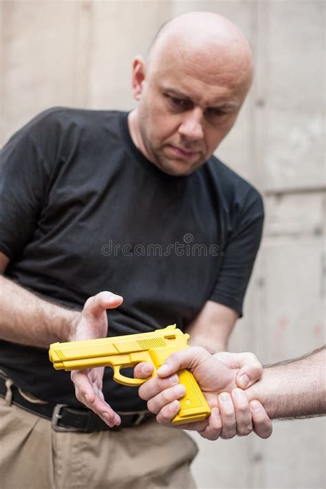 Gun Disarm. Self Defense Techniques Against a Gun Point. Stock Photo ...