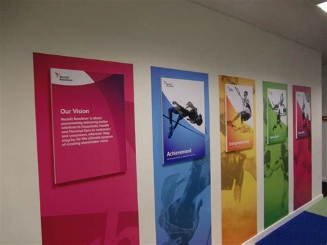 an office hallway with colorful banners on the wall and blue carpeting ...