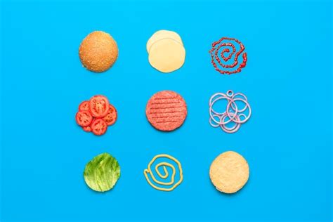 Premium Photo | Burger ingredients top view isolated on blue background