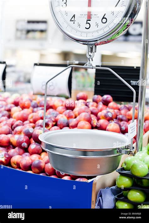 Grocery store scale with fruit and vegetables in background Stock Photo ...