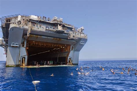 Sailors and Marines from the multipurpose amphibious assault ship USS ...