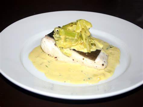 Poached halibut with creamy white wine and tarragon sauce | WizardRecipes