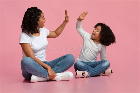 Loving Black Mother and Daughter Giving High Five To Each Other Stock ...