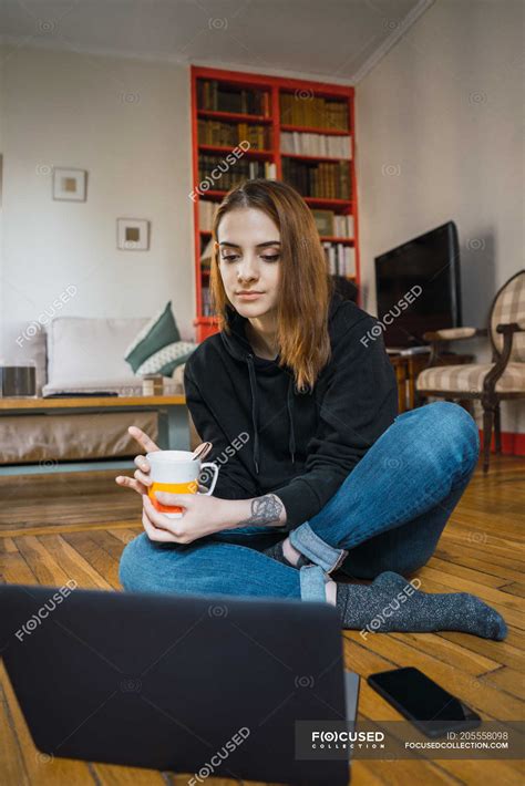 Woman sitting with laptop on floor — using, enjoy - Stock Photo ...