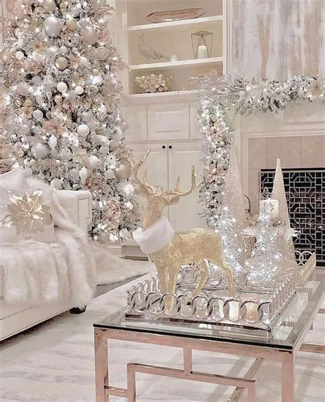 a white christmas tree in a living room next to a fire place and other ...