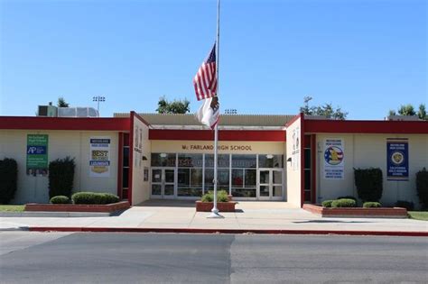 an american flag is flying in front of a school