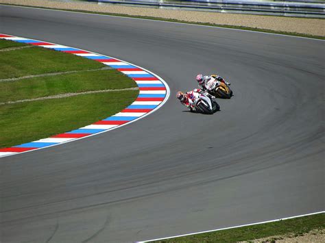 Red Racing Car on Race Track during Daytime · Free Stock Photo