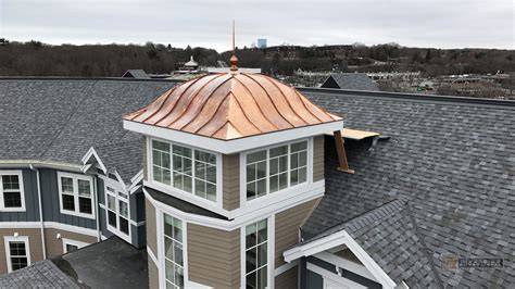 Copper cupola tower - eyebrow roof, standing seam panels with finial