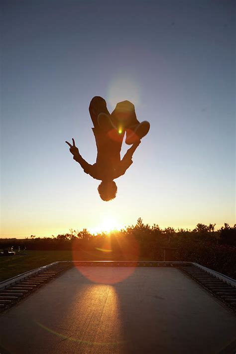 Man Doing Backflip On Trampoline Photograph by Ubald Rutar