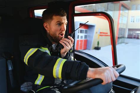 Firefighter Using Radio Set while Driving Fire Truck Stock Image ...