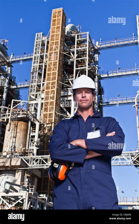 Worker standing at oil refinery Stock Photo - Alamy