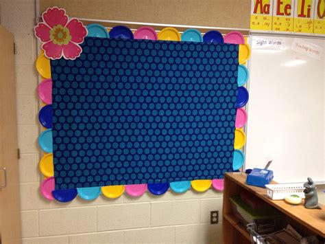 a bulletin board with flowers on it in a classroom