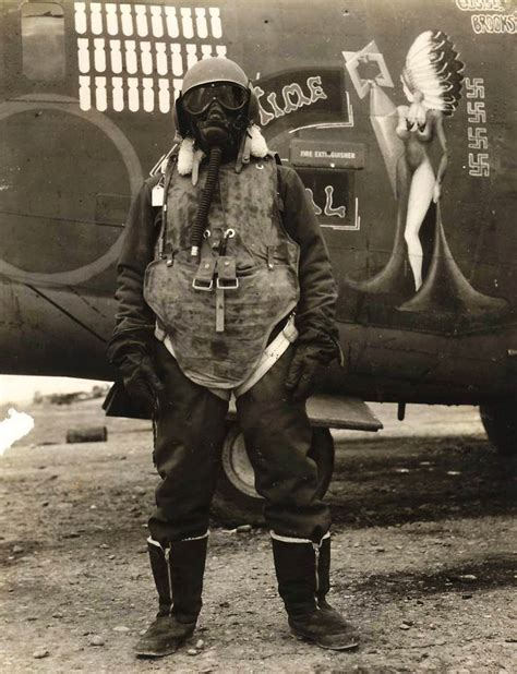 An airgunner stands before his B-24 bomber wearing what it took to ...