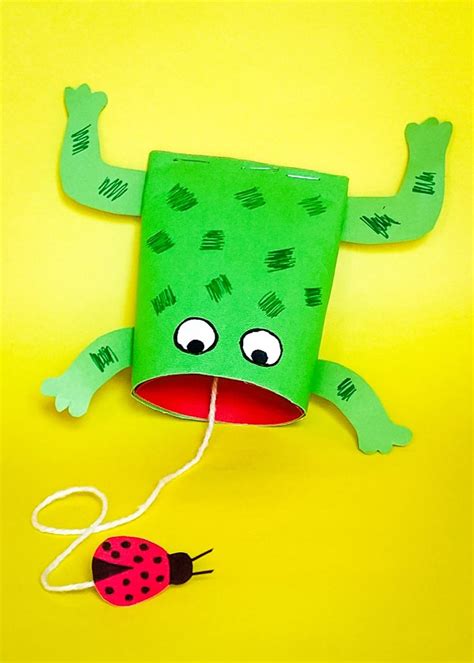 a green paper bag with a ladybug on it's face and legs