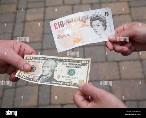 People exchanging a $10 dollar bill for a £10 pound note Stock Photo ...