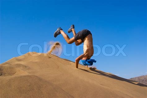 Fun jumping on sand dune | Stock image | Colourbox