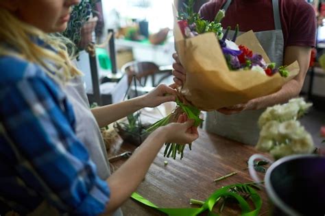 Premium Photo | Tying bouquet with ribbon