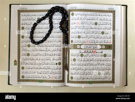 A copy of the sacred text of Islam Qur'an opened for reading with Stock ...