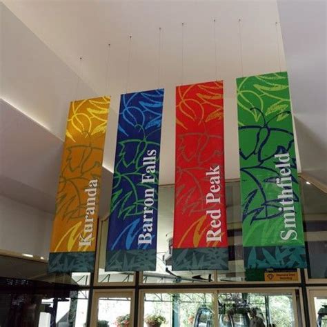 colorful banners hanging from the ceiling above a gym area with ...