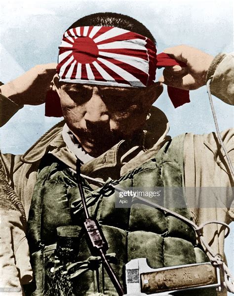 Japanese kamikaze putting on his forehead bandeau with rising sun ...