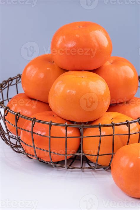 Fresh beautiful sliced sweet persimmon kaki isolated on white kitchen ...