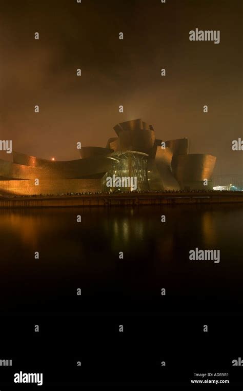 Guggenheim Museum Bilbao at night illuminated by the light of fireworks ...