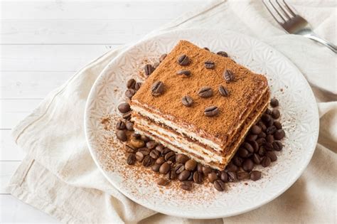 Premium Photo | Delicious tiramisu cake with coffee beans on a plate