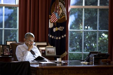 President Barack Obama works at the Resolute Desk in the Oval Office