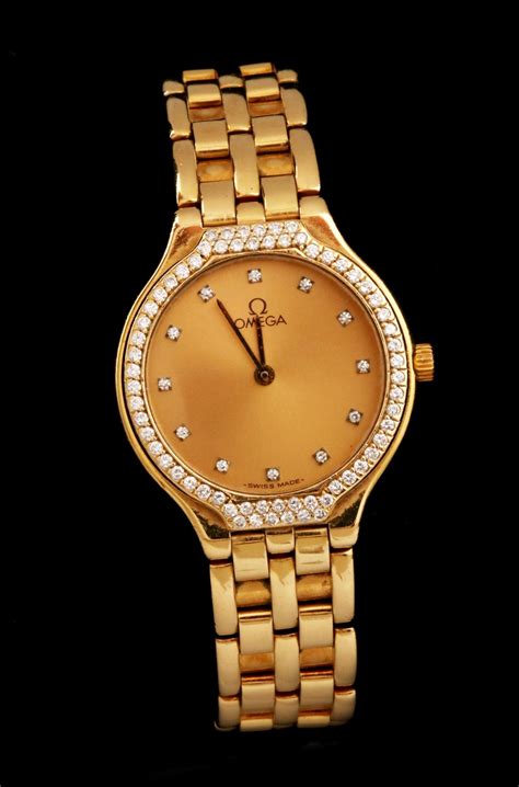 #53: LADIES' OMEGA DEVILLE 18K GOLD WATCH WITH DIAMONDS