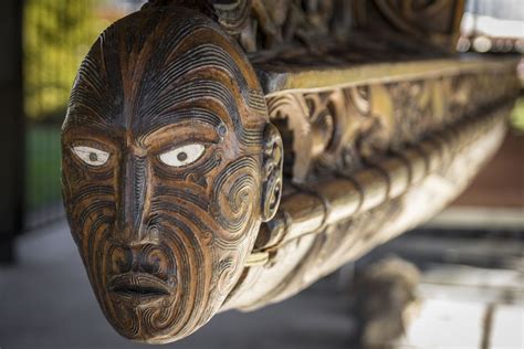 a close up of a wooden bench with carvings on it's face and eyes