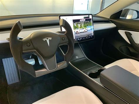 the interior of a car with an electronic device in the center and ...