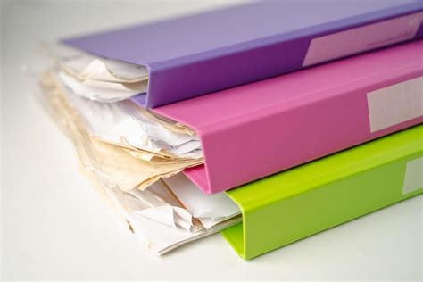 File Folder Binder stack of multi color on table in office. 3168903 ...