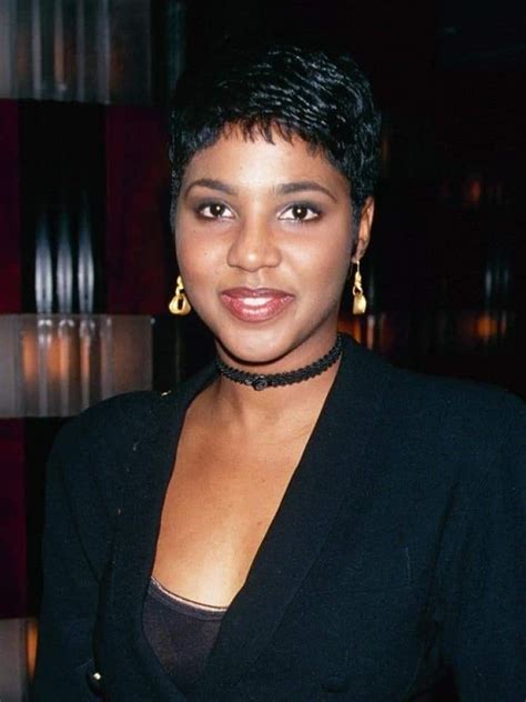 a woman with short hair wearing a black jacket