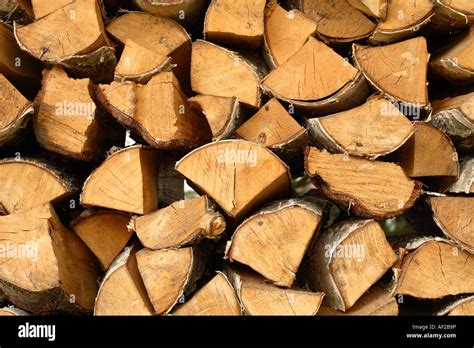 Cut logs firewood timber fuel for wood fire Stock Photo - Alamy