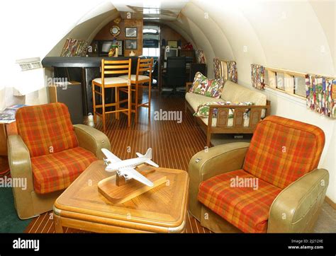 INTERIOR OF LIVING AREA WITH OWNER DAVE DRIMMER . THE PLANE BOAT IS A ...