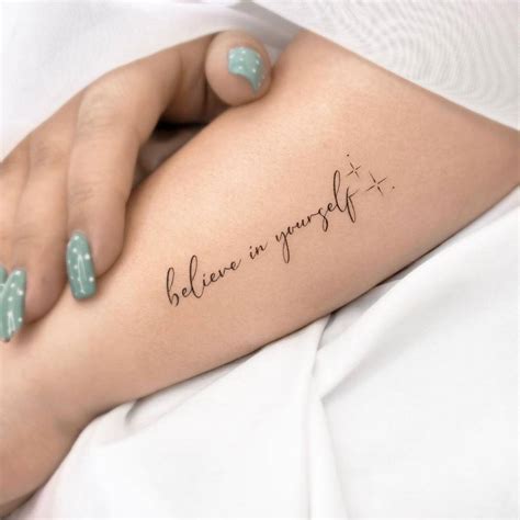 "Believe in yourself" lettering tattoo on the forearm.